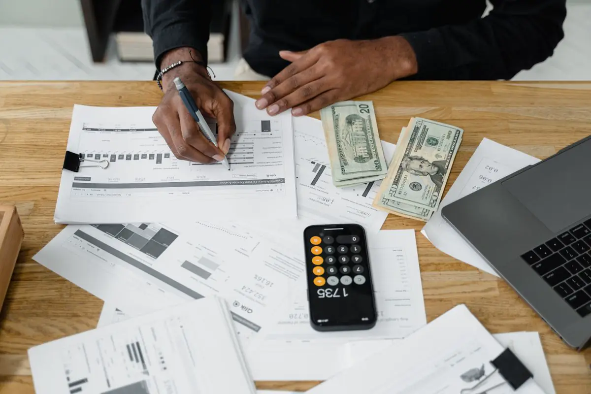 Accountant working with financial reports, a laptop and calculator